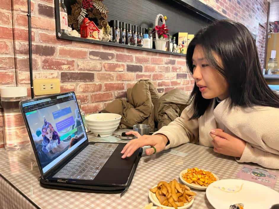 A user interacts with the Unicorn AI platform on a laptop, exploring immersive English learning features powered by AI, while seated in a cozy café environment.