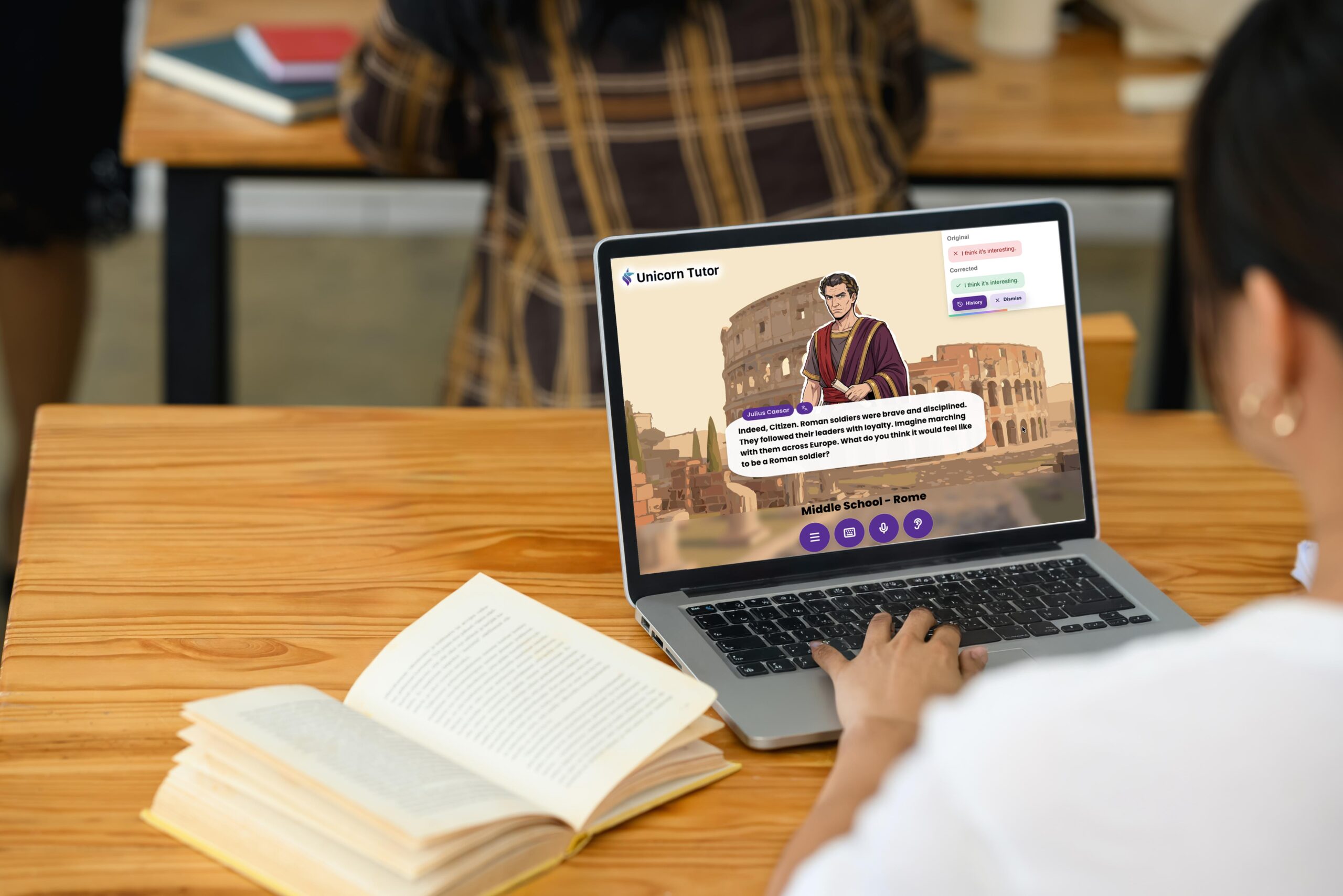 Educational content creator reviewing digital language learning materials and publishing analytics on a laptop in a modern workspace